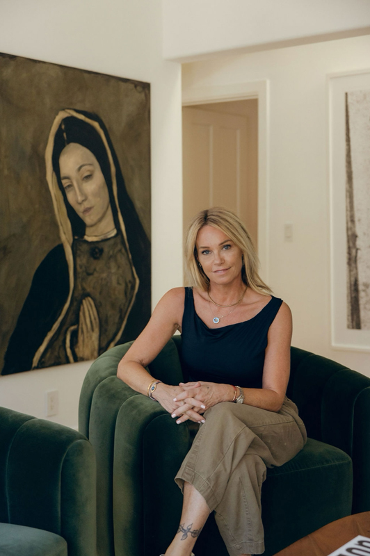 Stace King seated in a green armchair